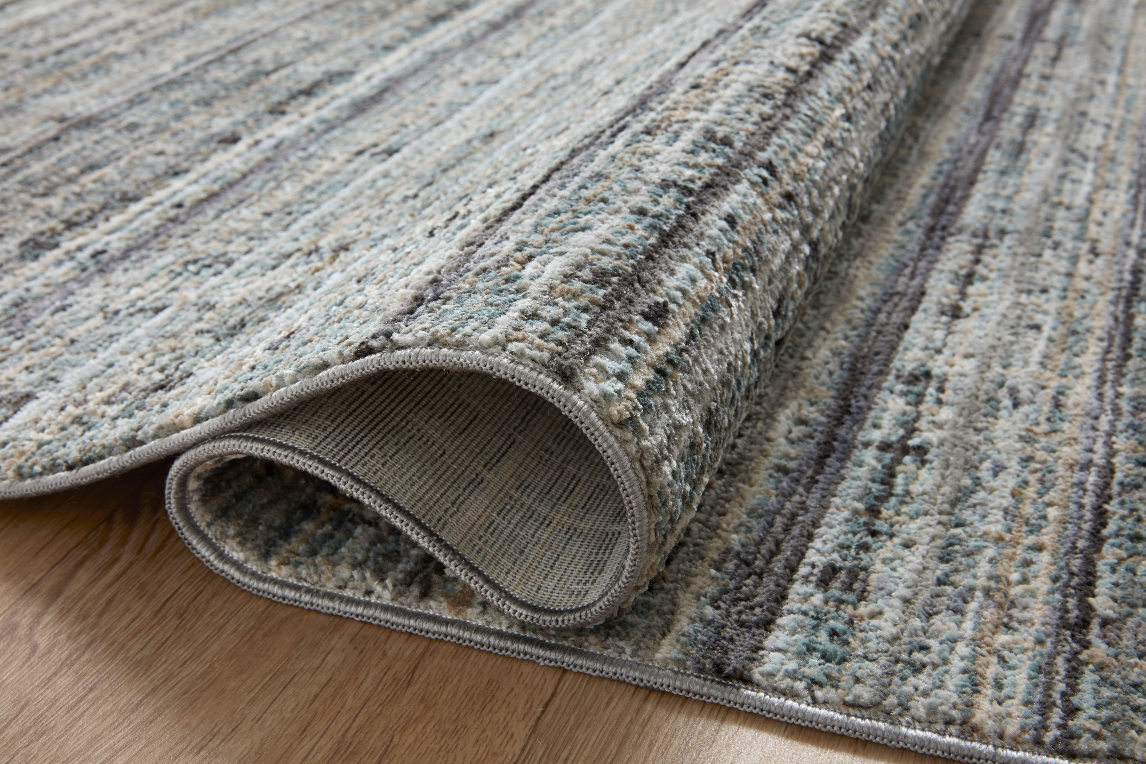 The Soho SOH-04 Jade / Stone Area Rug delivers refreshing jade and grounding stone beauty and contemporary and abstract elegance in a power-loomed 100% polyester area rug
