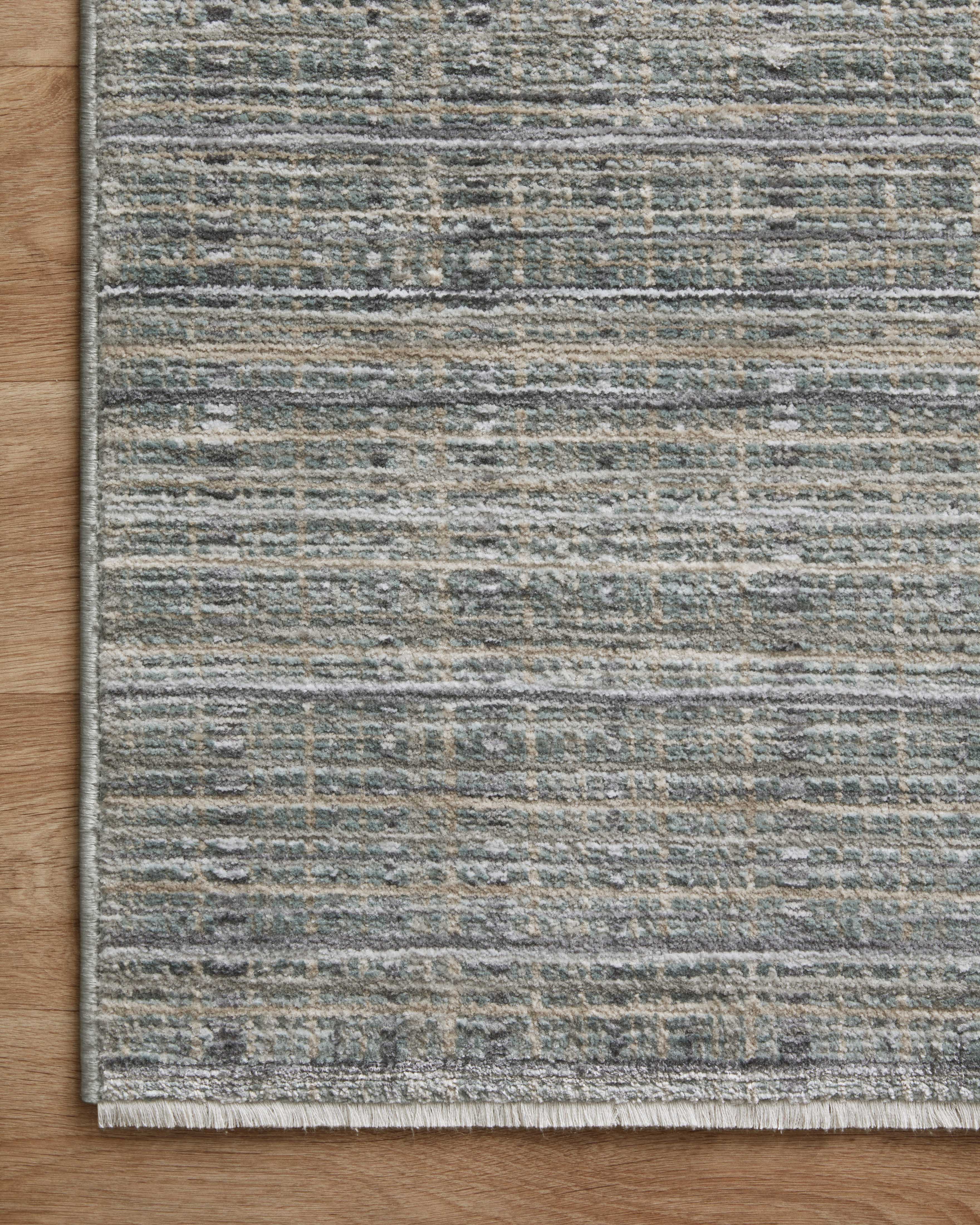 The Soho SOH-04 Jade / Stone Area Rug delivers refreshing jade and grounding stone beauty and contemporary and abstract elegance in a power-loomed 100% polyester area rug