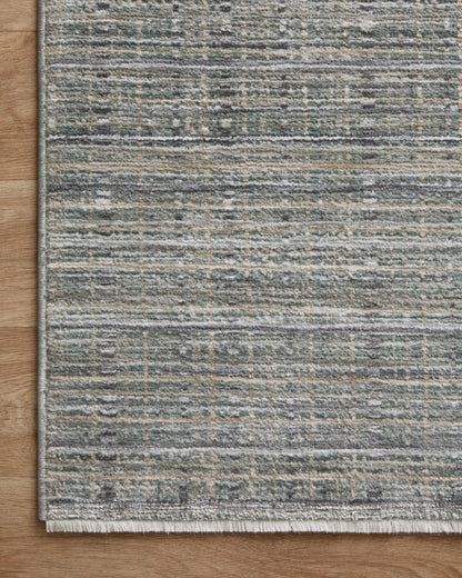 The Soho SOH-04 Jade / Stone Area Rug delivers refreshing jade and grounding stone beauty and contemporary and abstract elegance in a power-loomed 100% polyester area rug