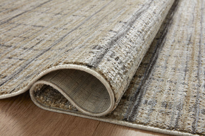 Designed with contemporary and abstract artistry in subtle pebble and deep charcoal hues, the Soho SOH-04 Pebble / Charcoal Area Rug is a power-loomed 100% polyester area rug that stands out
