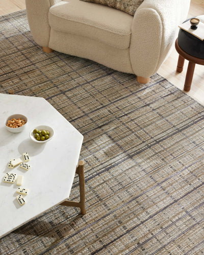 Designed with contemporary and abstract artistry in subtle pebble and deep charcoal hues, the Soho SOH-04 Pebble / Charcoal Area Rug is a power-loomed 100% polyester area rug that stands out