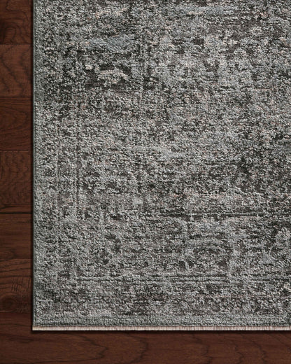 The Sonnet SNN-07 Charcoal / Mist Area Rug is a power-loomed polypropylene and polyester area rug that radiates deep charcoal and soft misty charm and traditional elegance