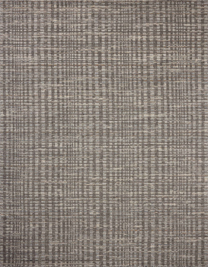 Dressed in striking granite and vibrant multi-toned hues with graphic detail, the Sonya SOY-05 Granite / Multi Area Rug is a hand-loomed wool area rug that completes any room