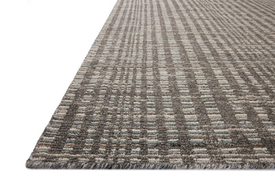 Dressed in striking granite and vibrant multi-toned hues with graphic detail, the Sonya SOY-05 Granite / Multi Area Rug is a hand-loomed wool area rug that completes any room