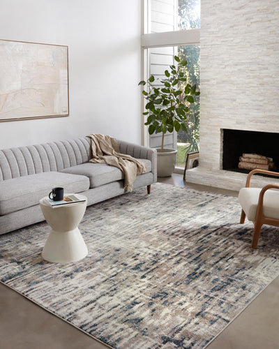 A power-loomed 100% polypropylene area rug with abstract design in grounding stone and calming blue hues, the Spirit SPI-02 Stone / Blue Area Rug is a standout in any décor