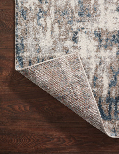 A power-loomed 100% polypropylene area rug with abstract design in grounding stone and calming blue hues, the Spirit SPI-02 Stone / Blue Area Rug is a standout in any décor