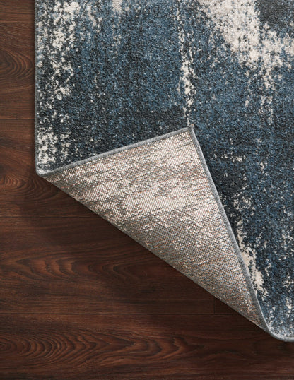 Dressed in deep indigo and refined ivory hues with abstract detail, the Spirit SPI-04 Indigo / Ivory Area Rug is a power-loomed 100% polypropylene area rug that completes any room