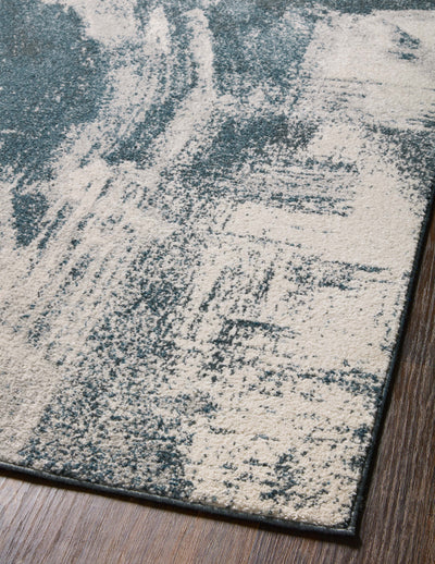 Dressed in deep indigo and refined ivory hues with abstract detail, the Spirit SPI-04 Indigo / Ivory Area Rug is a power-loomed 100% polypropylene area rug that completes any room