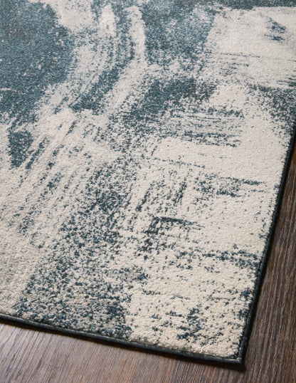 Dressed in deep indigo and refined ivory hues with abstract detail, the Spirit SPI-04 Indigo / Ivory Area Rug is a power-loomed 100% polypropylene area rug that completes any room