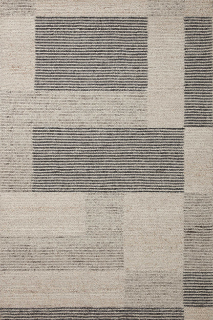 The Stiles STI-01 Dove / Ink Area Rug is a hand-tufted 100% wool area rug that radiates gentle dove and bold ink charm and colorblock and ribbed elegance