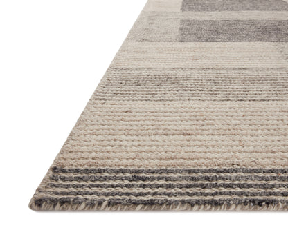 The Stiles STI-01 Dove / Ink Area Rug is a hand-tufted 100% wool area rug that radiates gentle dove and bold ink charm and colorblock and ribbed elegance