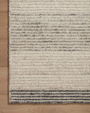 The Stiles STI-01 Dove / Ink Area Rug is a hand-tufted 100% wool area rug that radiates gentle dove and bold ink charm and colorblock and ribbed elegance