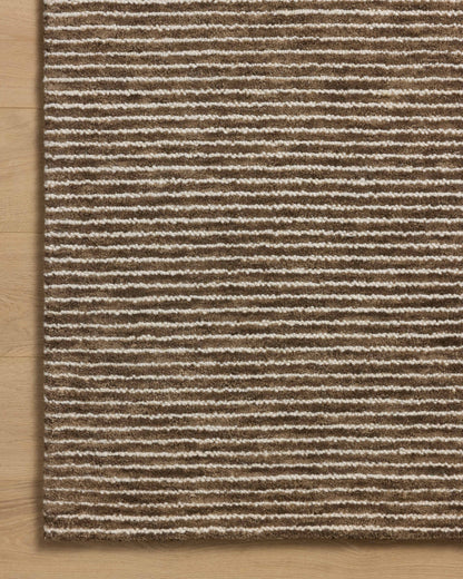 With luxurious mocha and refined ivory hues, the Sunday SUN-01 Mocha / Ivory Area Rug is a hand-tufted wool area rug that elevates any room