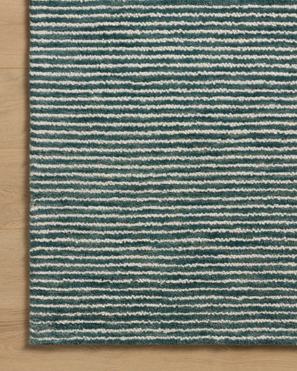 The Sunday SUN-01 Ocean / Ivory Area Rug blends serene ocean and refined ivory tones into a hand-tufted wool area rug with timeless appeal