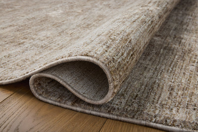 Crafted as a power-loomed polyester area rug, the Tabitha TAI-02 Taupe / Pebble Area Rug brings versatile taupe and subtle pebble warmth and traditional character to your space