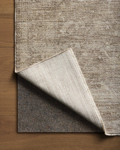 Crafted as a power-loomed polyester area rug, the Tabitha TAI-02 Taupe / Pebble Area Rug brings versatile taupe and subtle pebble warmth and traditional character to your space