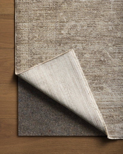 Crafted as a power-loomed polyester area rug, the Tabitha TAI-02 Taupe / Pebble Area Rug brings versatile taupe and subtle pebble warmth and traditional character to your space