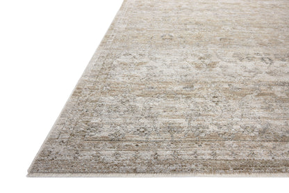 With refined ivory and khaki hues and traditional styling, the Tabitha TAI-03 Ivory / Khaki Area Rug is a power-loomed polyester area rug that elevates any room