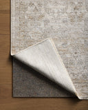 With refined ivory and khaki hues and traditional styling, the Tabitha TAI-03 Ivory / Khaki Area Rug is a power-loomed polyester area rug that elevates any room