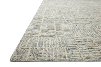 The Tallulah TLL-03 Sky / Ivory Area Rug pairs breezy sky-blue and refined ivory tones and abstract and linear patterns in a hand-tufted 100% wool area rug