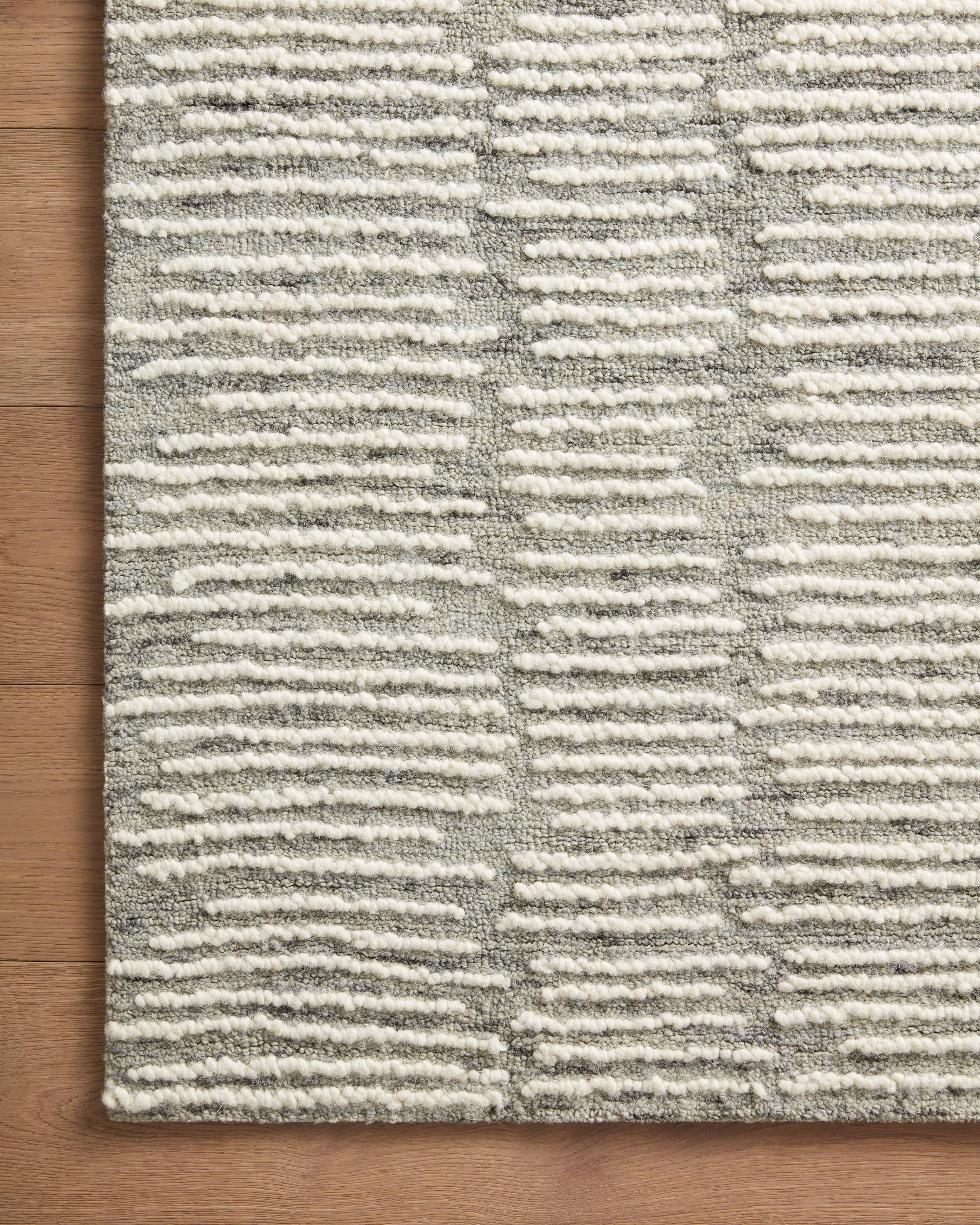 Crafted as a hand-tufted 100% wool area rug, the Tallulah TLL-04 Stone / Ivory Area Rug brings grounding stone and refined ivory warmth and abstract and linear character to your space