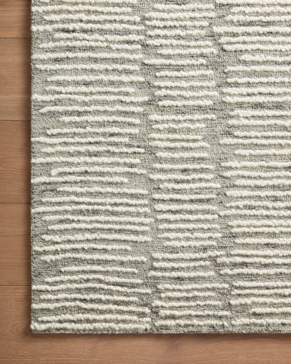 Crafted as a hand-tufted 100% wool area rug, the Tallulah TLL-04 Stone / Ivory Area Rug brings grounding stone and refined ivory warmth and abstract and linear character to your space