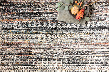 The Theia THE-08 Grey / Multi Area Rug pairs elegant grey and vibrant multi-toned tones with a power-loomed polyester pile and rayon area rug for lasting style