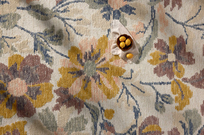Crafted as a hand-tufted wool area rug, the Tilly TIL-03 Bone / Multi Area Rug brings bone and vibrant multi-toned warmth and floral and high-low textured character to your space