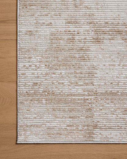 Designed with abstract artistry in sandy and warm beige hues, the Townes TOW-03 Sand / Beige Area Rug is a power-loomed polyester area rug that stands out
