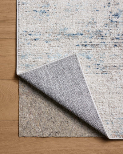 The Townes TOW-04 Ivory / Sky Area Rug combines refined ivory and breezy sky-blue tones and abstract patterns in a power-loomed polyester area rug for effortless elegance