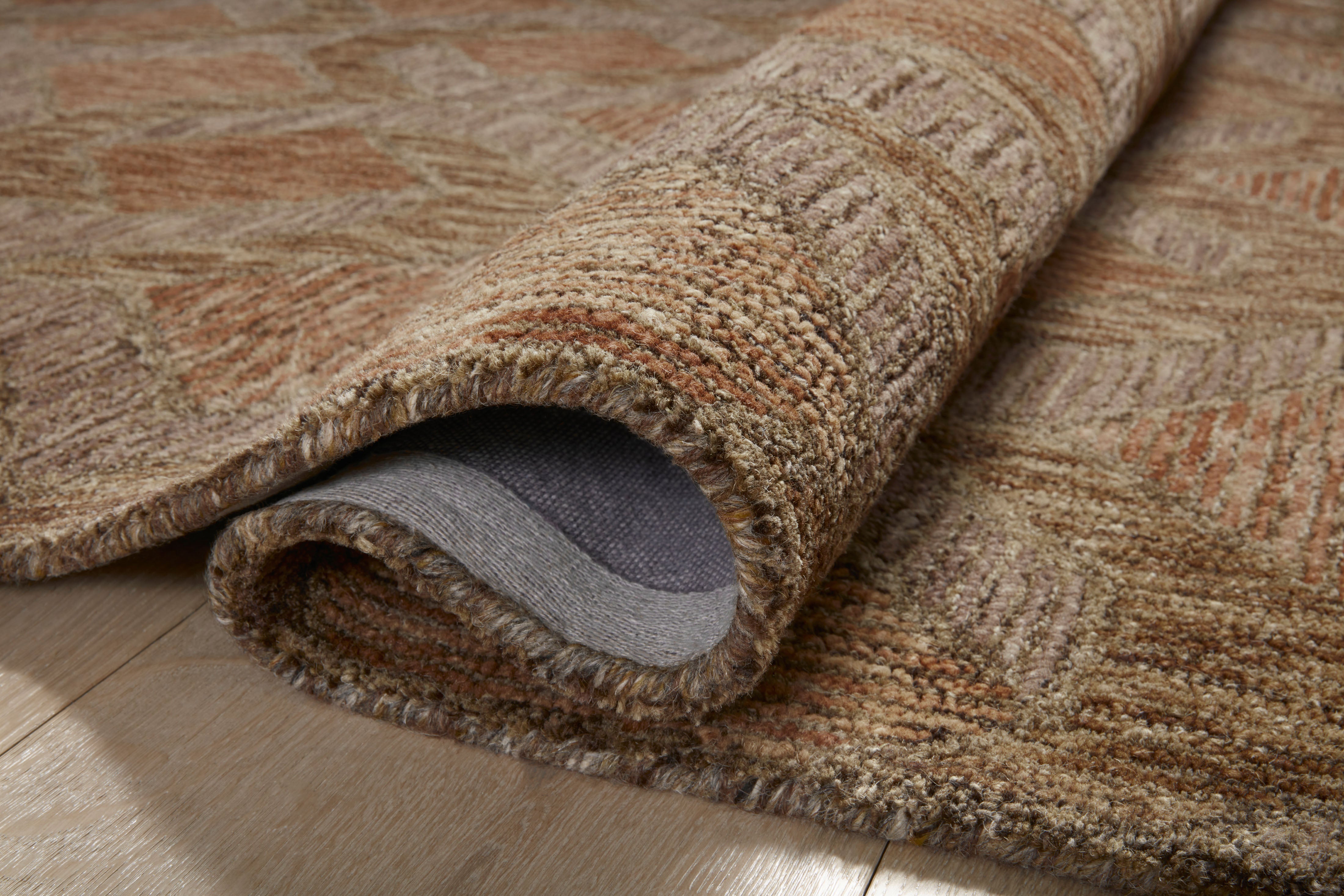 Finished in warm rust and grounded bark tones with graphic styling, the Varena VAR-03 Rust / Bark Area Rug is a hand-tufted 100% wool area rug for modern living