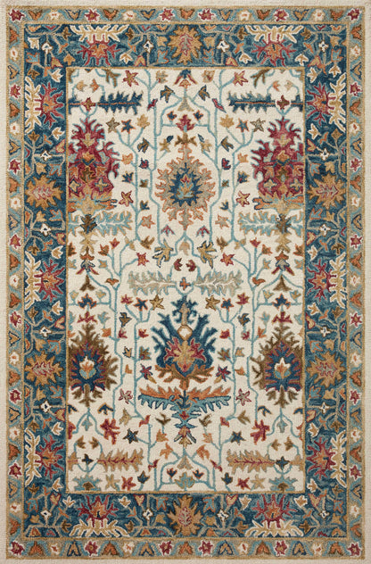 Layered in refined ivory and breezy sky-blue hues with traditional patterns, the Victoria VK-23 Ivory / Sky Area Rug is a hooked 100% wool area rug perfect for any setting