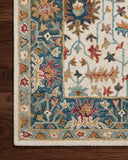 Layered in refined ivory and breezy sky-blue hues with traditional patterns, the Victoria VK-23 Ivory / Sky Area Rug is a hooked 100% wool area rug perfect for any setting