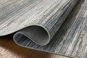 A power-loomed 100% polyester area rug with abstract and linear flair in serene ocean and sandy tones, the Wade WAE-02 Ocean / Sand Area Rug anchors any room