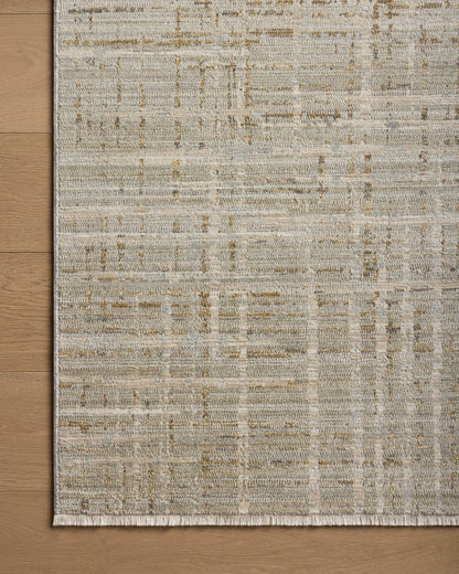 Crafted as a power-loomed 100% polyester area rug, the Wade WAE-03 Mist / Gold Area Rug brings soft misty and radiant gold warmth and abstract and linear character to your space