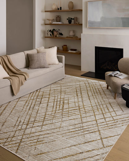 The Wade WAE-04 Beige / Gold Area Rug blends warm beige and radiant gold tones and abstract and linear motifs into a power-loomed 100% polyester area rug with timeless appeal