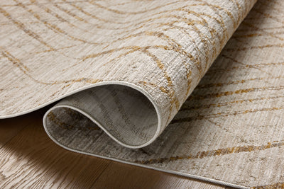 The Wade WAE-04 Beige / Gold Area Rug blends warm beige and radiant gold tones and abstract and linear motifs into a power-loomed 100% polyester area rug with timeless appeal