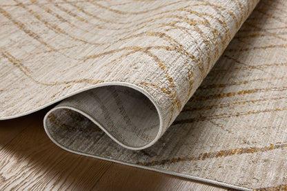The Wade WAE-04 Beige / Gold Area Rug blends warm beige and radiant gold tones and abstract and linear motifs into a power-loomed 100% polyester area rug with timeless appeal