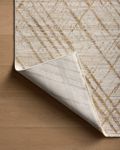 The Wade WAE-04 Beige / Gold Area Rug blends warm beige and radiant gold tones and abstract and linear motifs into a power-loomed 100% polyester area rug with timeless appeal