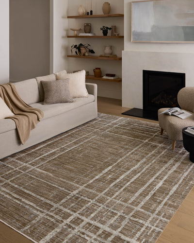 Designed with abstract and linear artistry in brown and grounding stone hues, the Wade WAE-05 Brown / Stone Area Rug is a power-loomed 100% polyester area rug that stands out