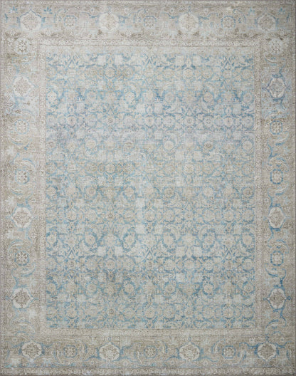 A power-loomed 100% polyester area rug in serene ocean and shimmering silver tones, the Wynter WYN-10 Ocean / Silver Area Rug anchors any room