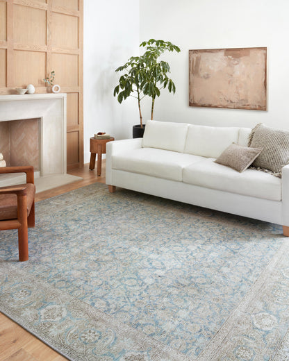 A power-loomed 100% polyester area rug in serene ocean and shimmering silver tones, the Wynter WYN-10 Ocean / Silver Area Rug anchors any room
