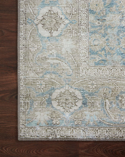 A power-loomed 100% polyester area rug in serene ocean and shimmering silver tones, the Wynter WYN-10 Ocean / Silver Area Rug anchors any room