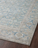 A power-loomed 100% polyester area rug in serene ocean and shimmering silver tones, the Wynter WYN-10 Ocean / Silver Area Rug anchors any room