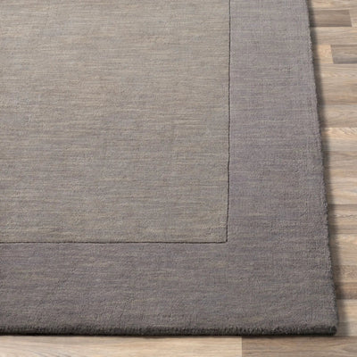 Livabliss Mystique M-312 charcoal area rug with high-low pile texture and defined border on wood flooring.