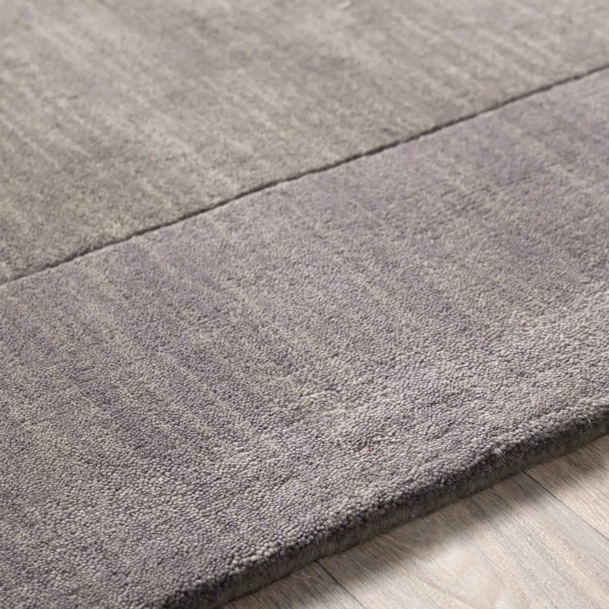 Livabliss Mystique M-312 charcoal wool area rug featuring a modern high/low pile texture and hand-loomed craftsmanship for contemporary interiors.