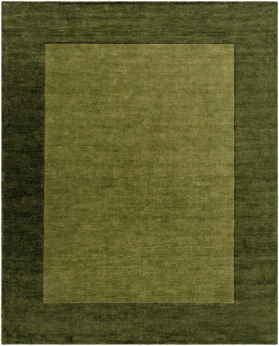 Livabliss Mystique M-315 Olive area rug with dark border and lighter center, featuring a textured wool pile and traditional hand-loomed design.