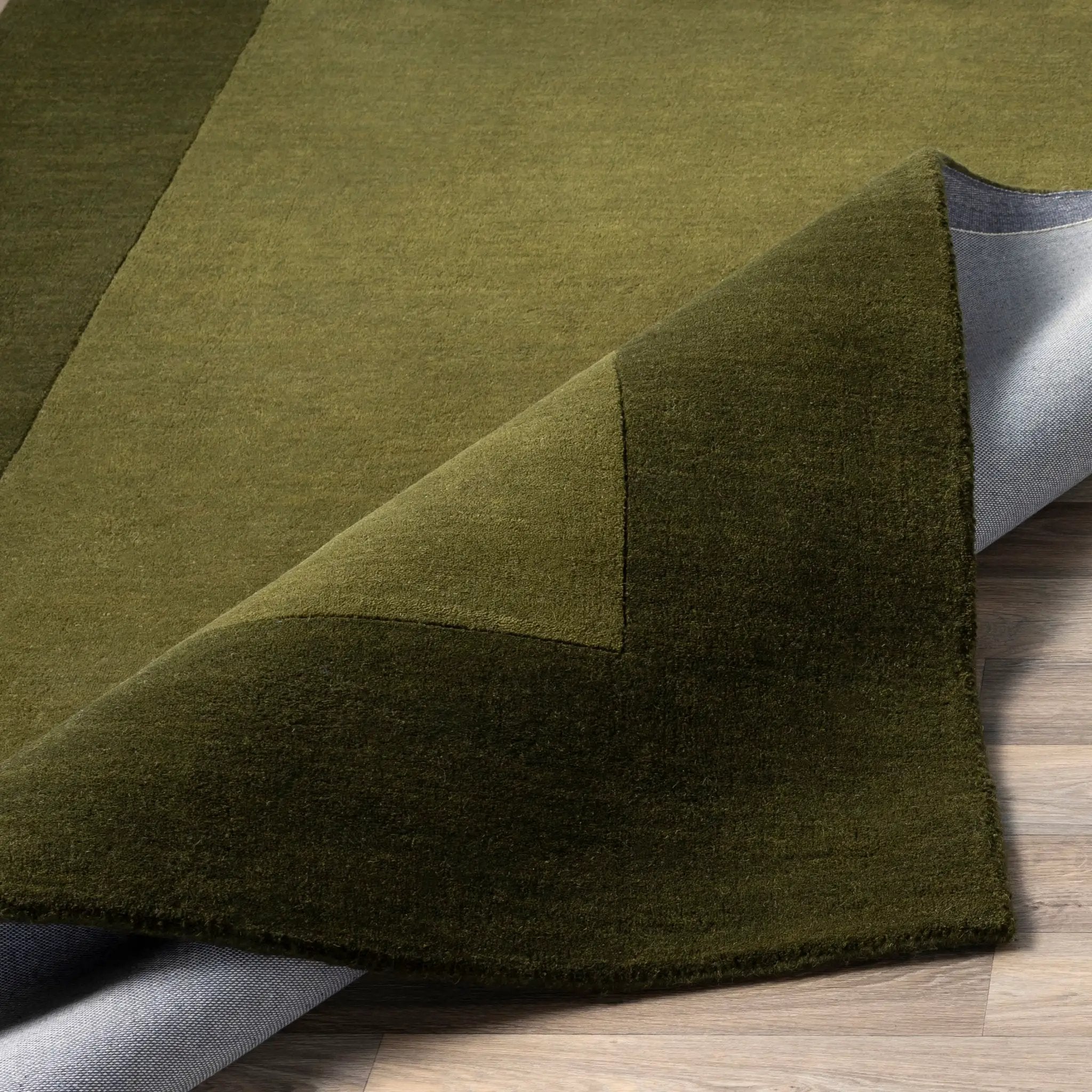 Livabliss Mystique M-315 Olive wool area rug featuring dynamic high and low pile texture, traditional hand-loomed construction, and a modern solid design.