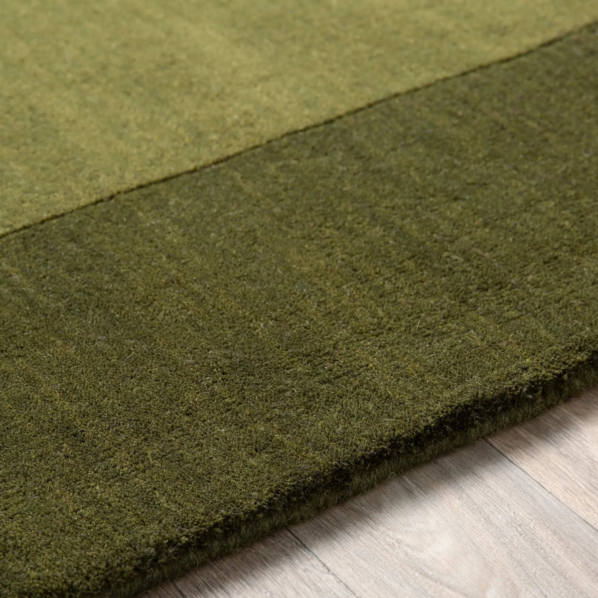 Livabliss Mystique M-315 Olive wool area rug featuring a dynamic high and low pile layout with traditional hand-loomed texture and structural resilience.