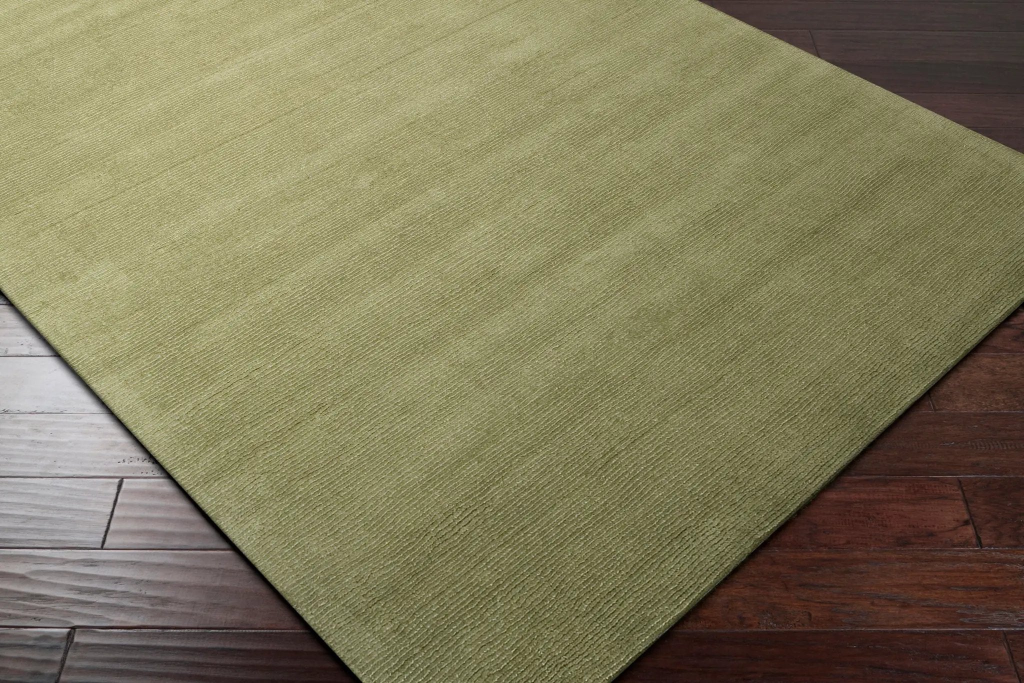 Livabliss Mystique M-329 Sage area rug with sculpted high-low wave pattern and textured surface on dark wood flooring.